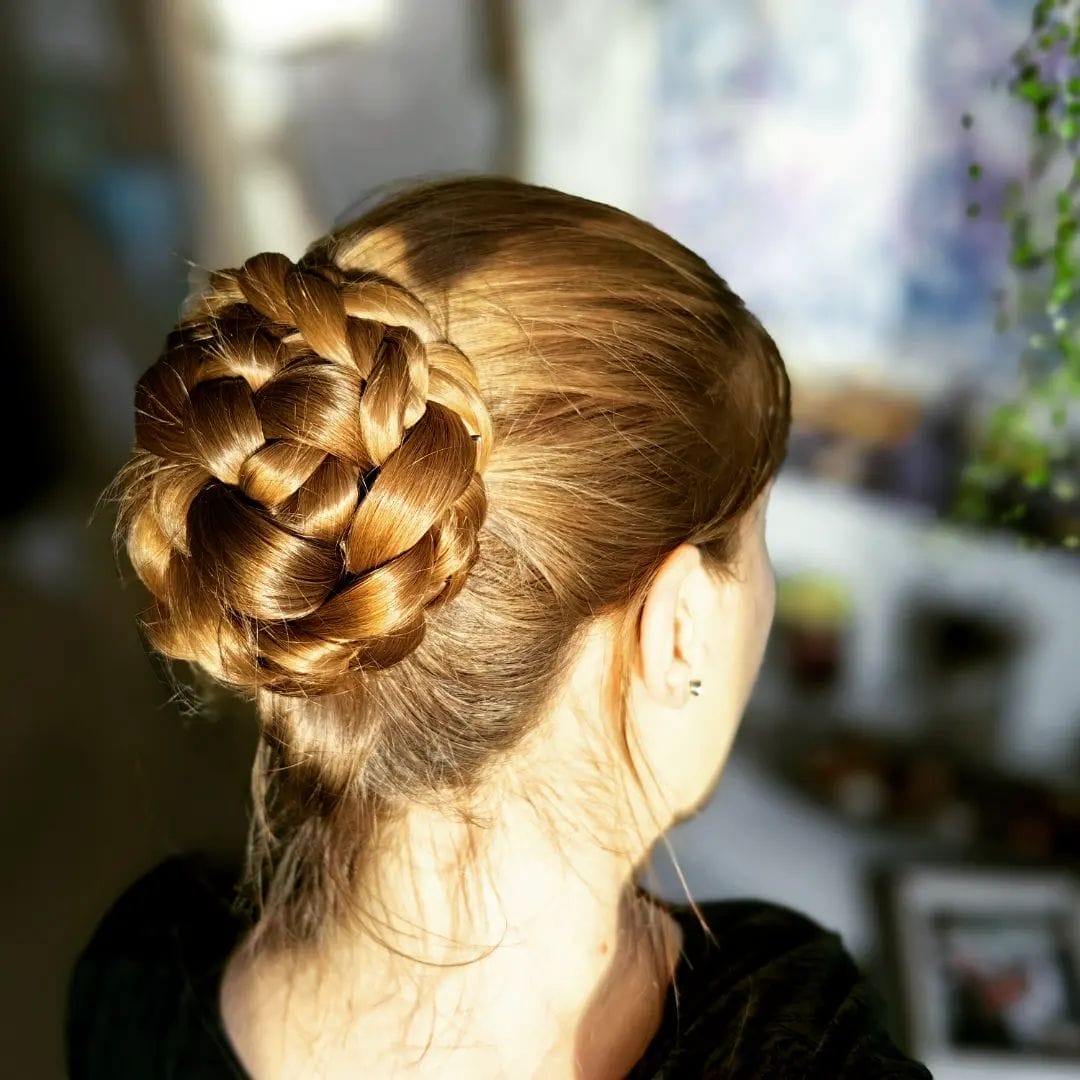 Neat honey-blonde braided high bun