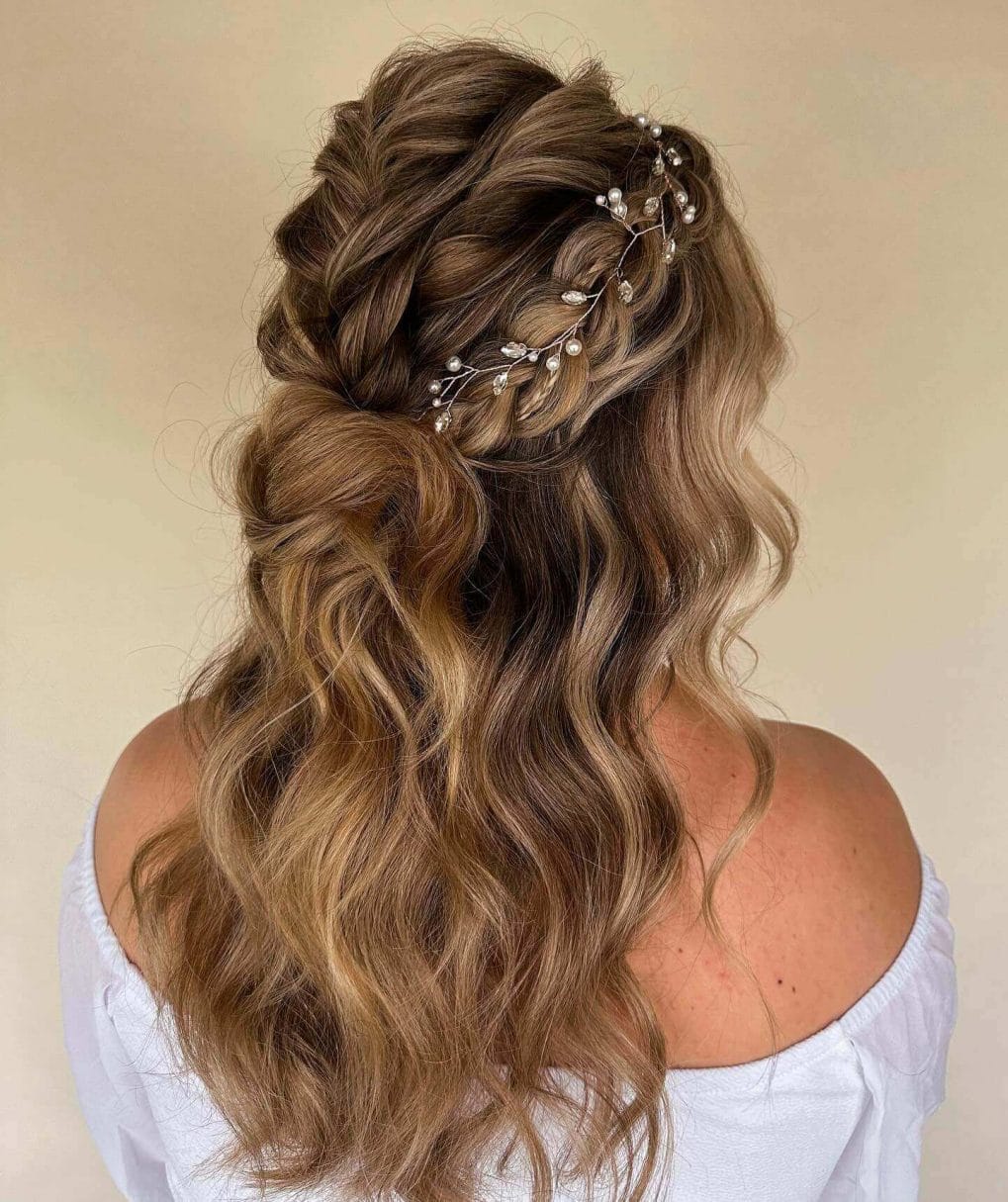 Honey-blonde French braid with delicate hair accessories