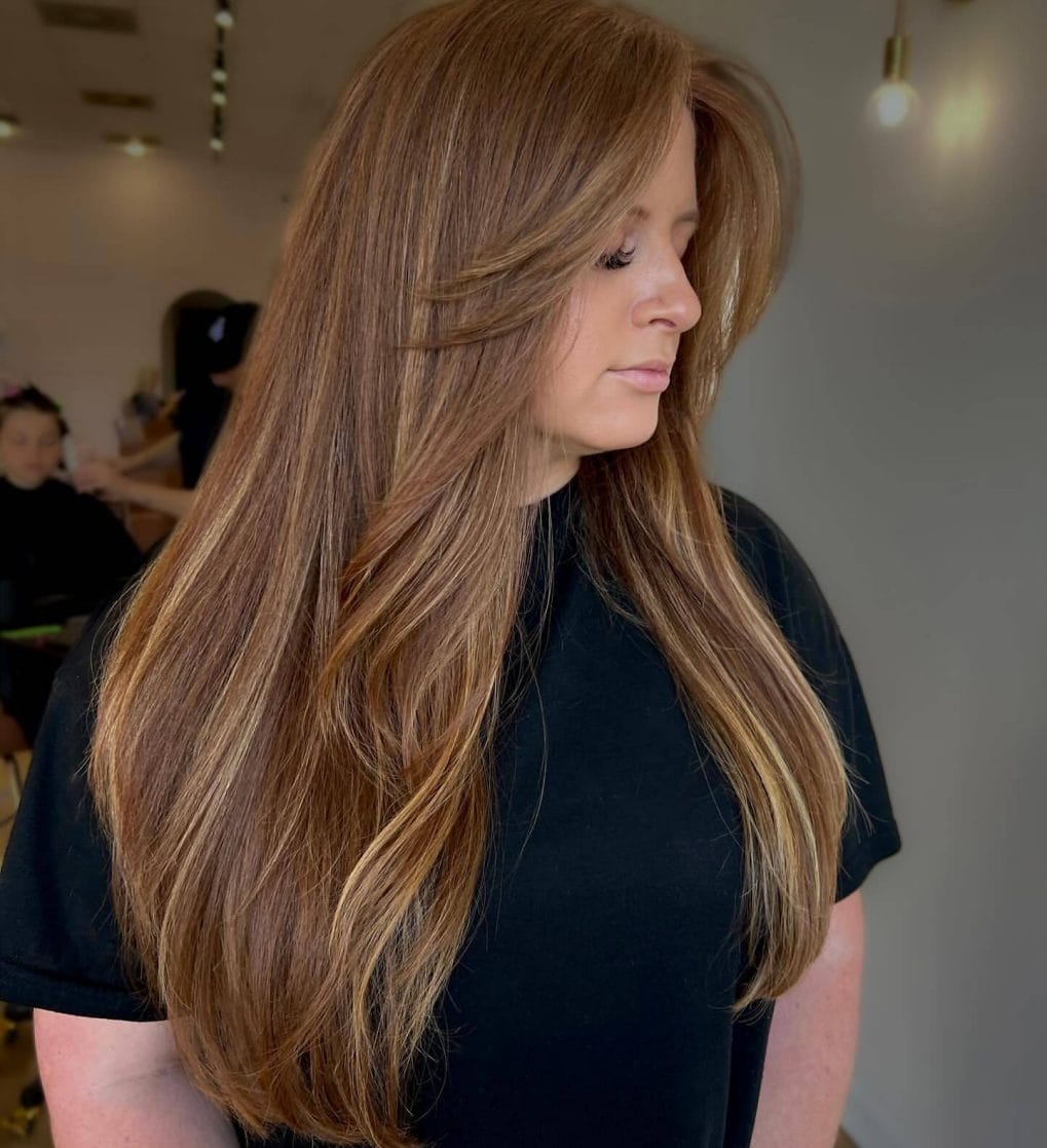 Honey-brown layers with 90s side-swept bangs