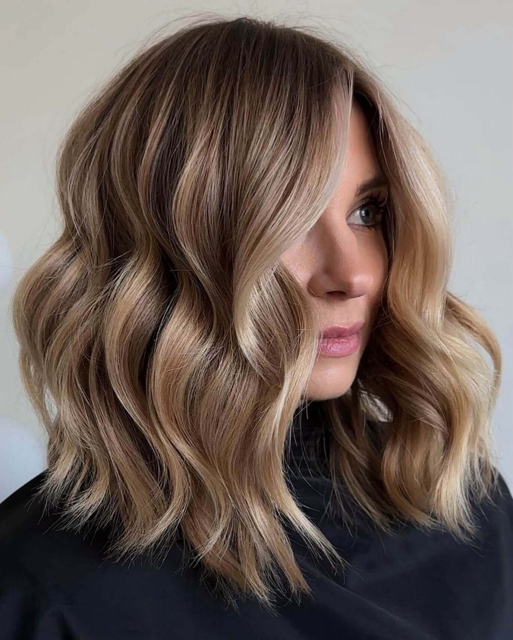 Versatile honeyed blonde textured lob with beachy waves