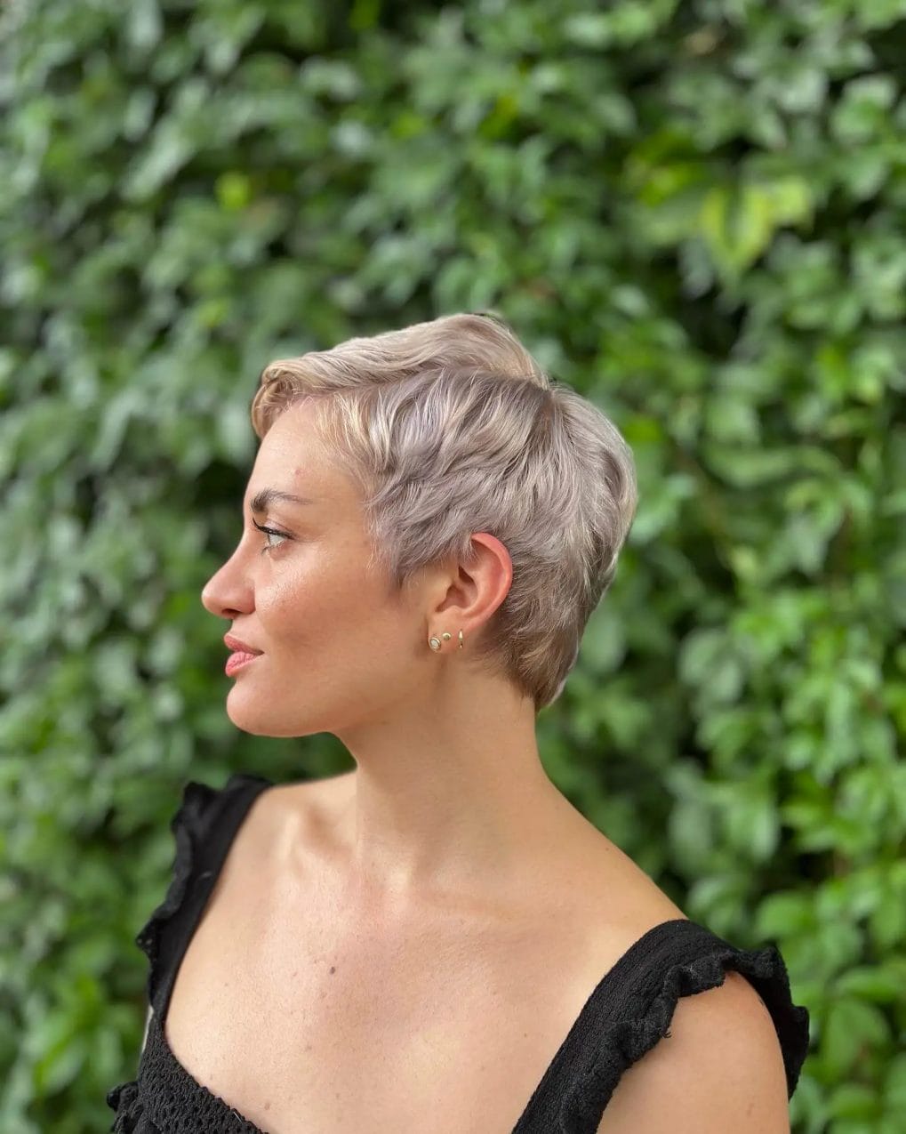 Icy blonde balayage on a textured wavy pixie.