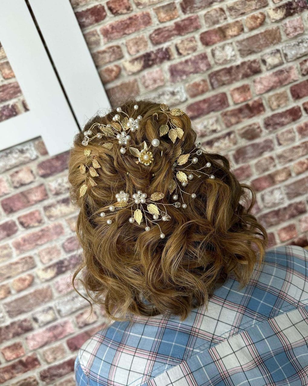 Intricate updo with floral accessories and loose curls
