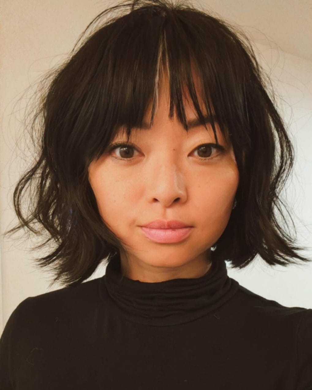 French bob with jet-black color and textured bangs