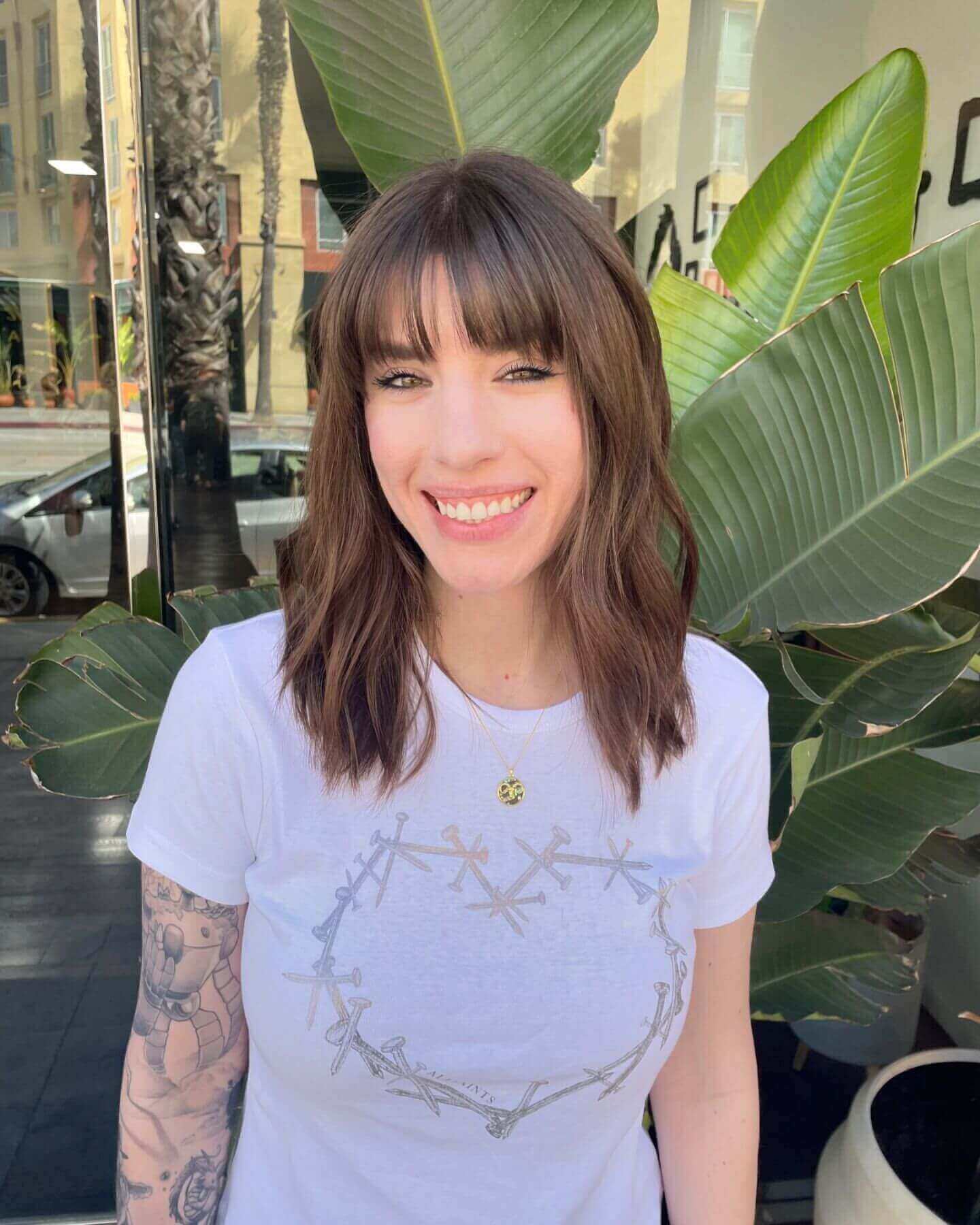Medium-length light brown waves with see-through bangs