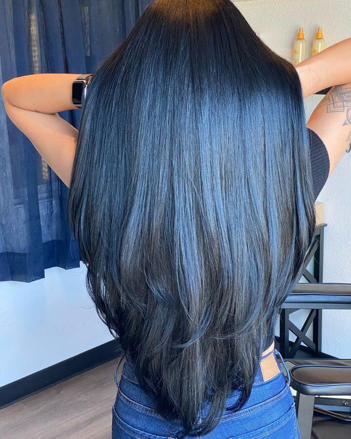 Chic V-layered cut on long hair for a modern angled finish.