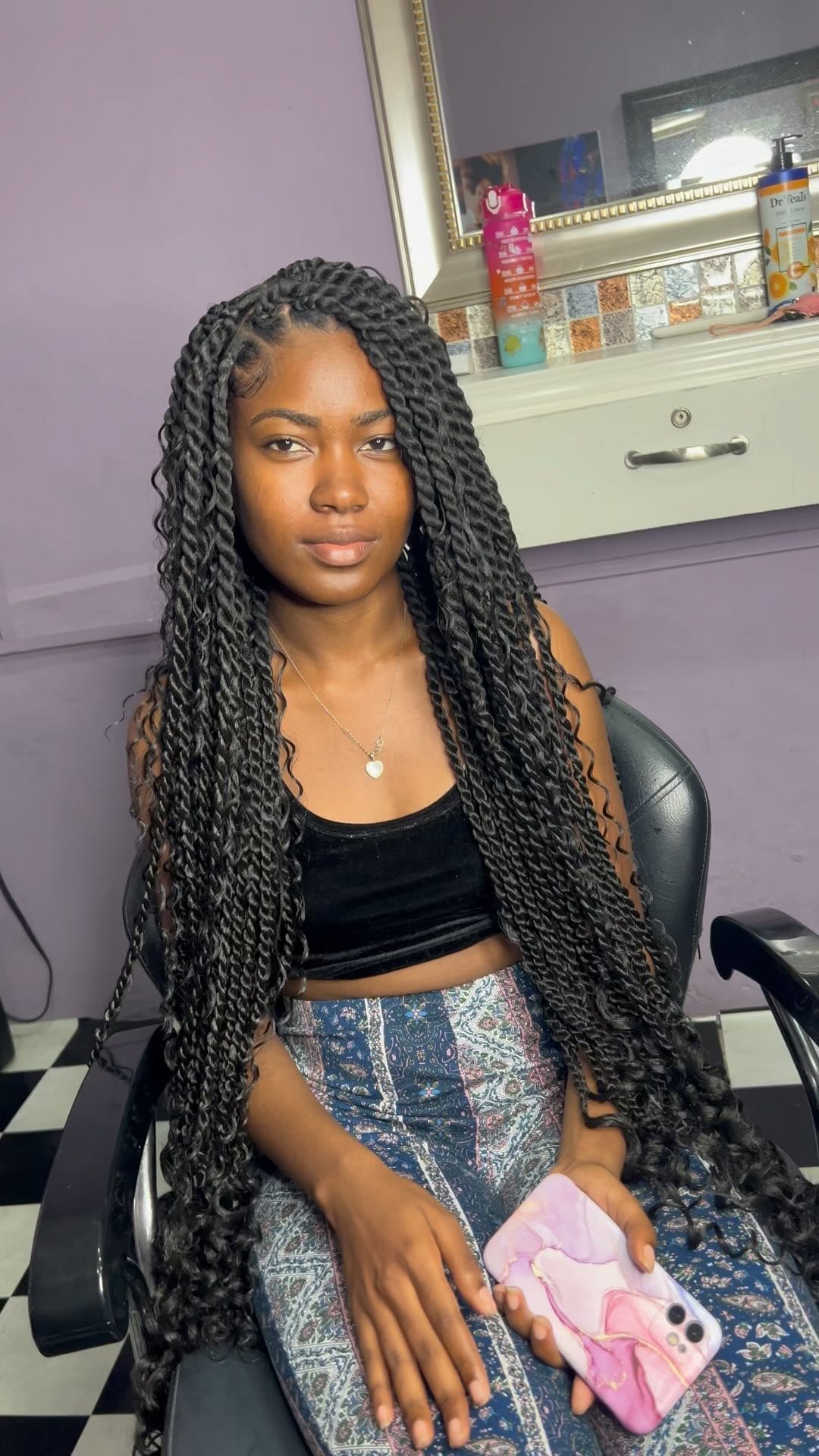 Full, long black kinky twists with gentle parting past shoulders