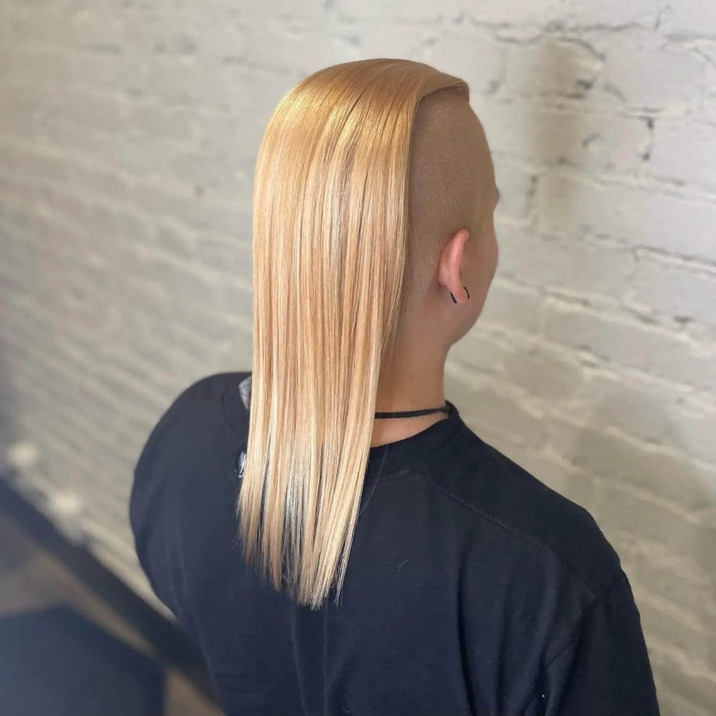 Long, sleek blonde hair with a daring undercut at the back, buzzed close to the scalp.
