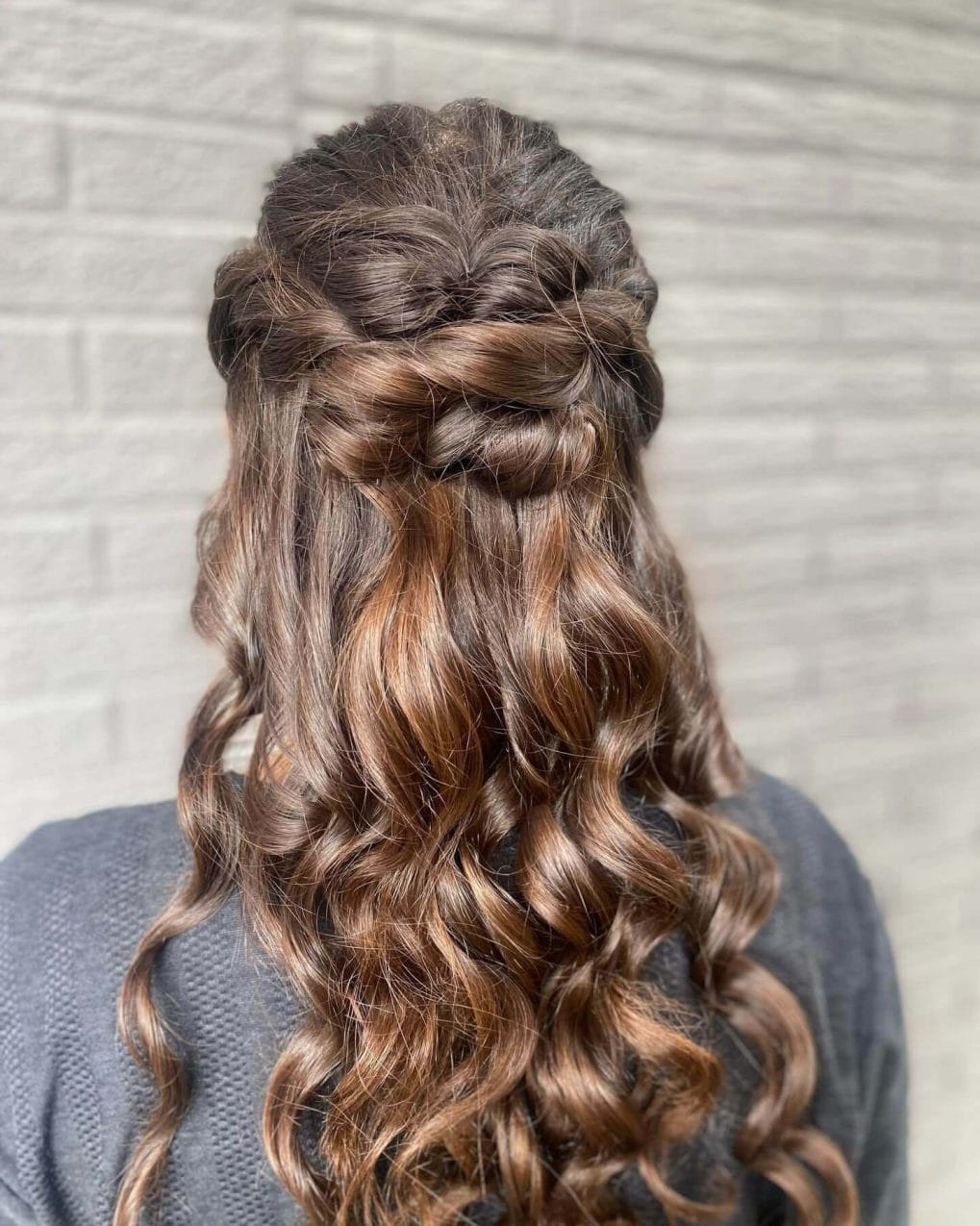 Long brunette hair with soft curls and twisted half-up style