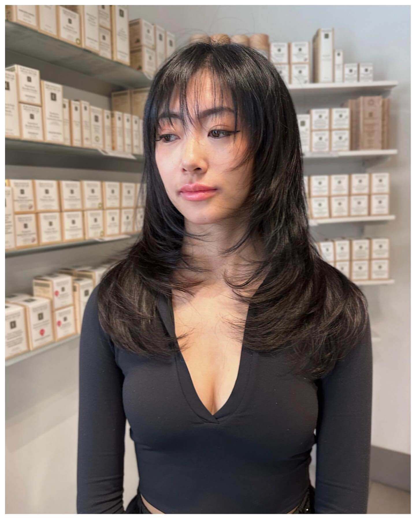 Long dark layered hair with see-through bangs