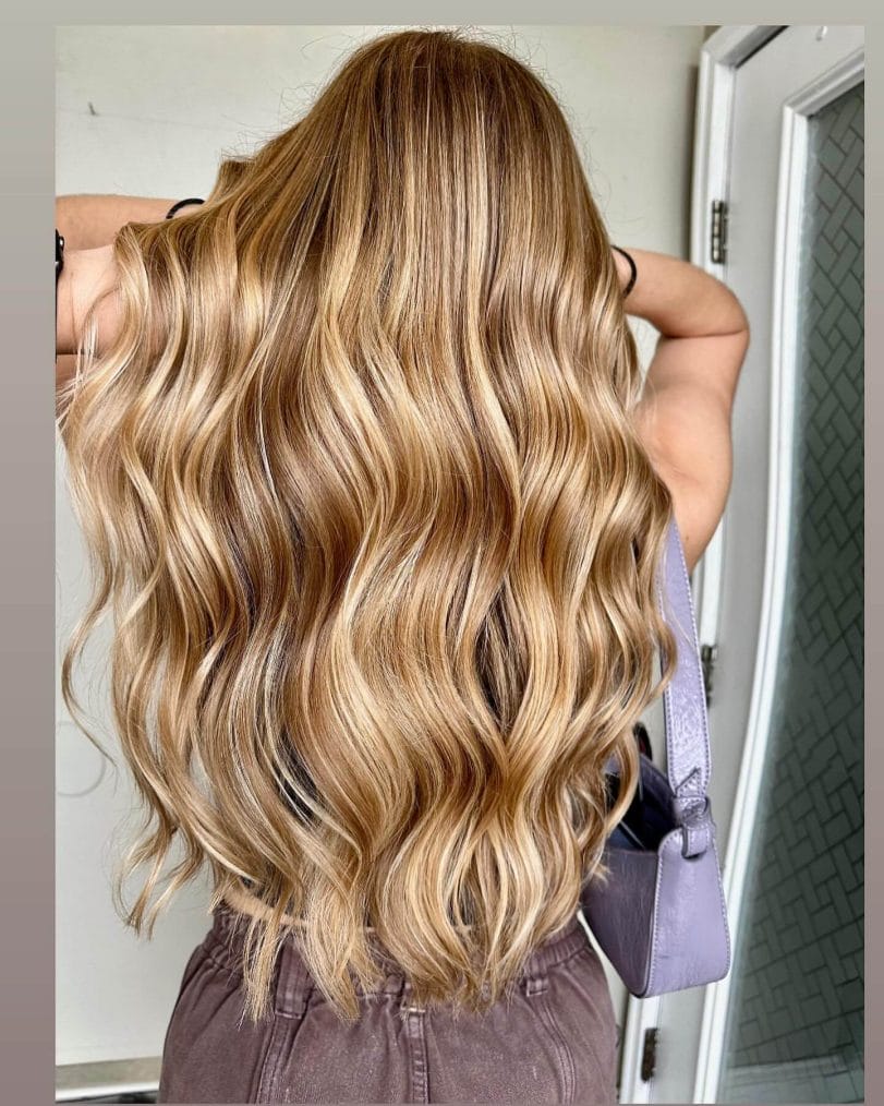 Long flowing waves with sunlit blonde and light brown balayage