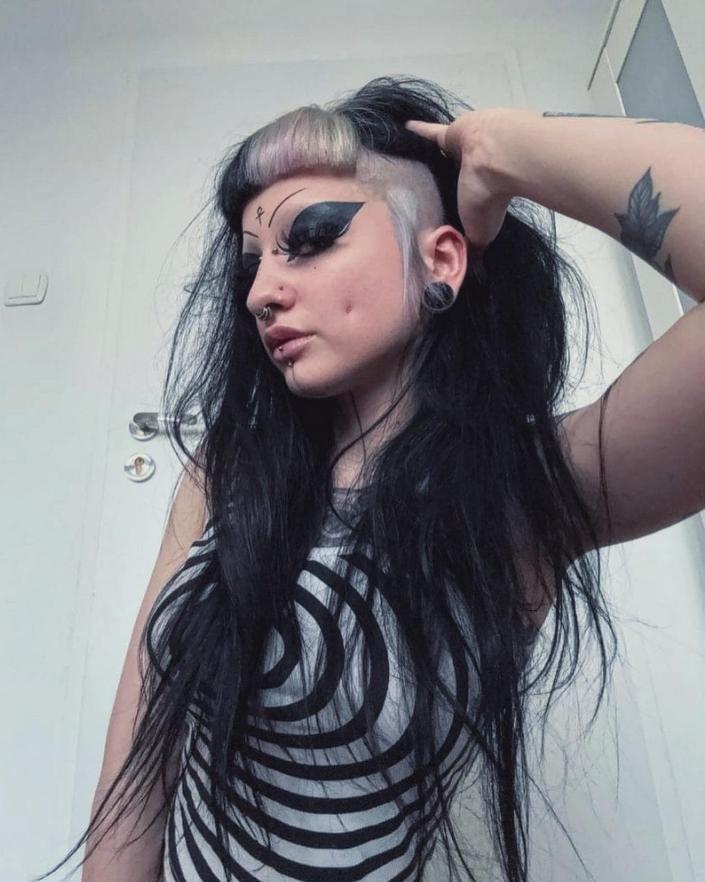 Long flowing hair with a side shave and asymmetrical edge