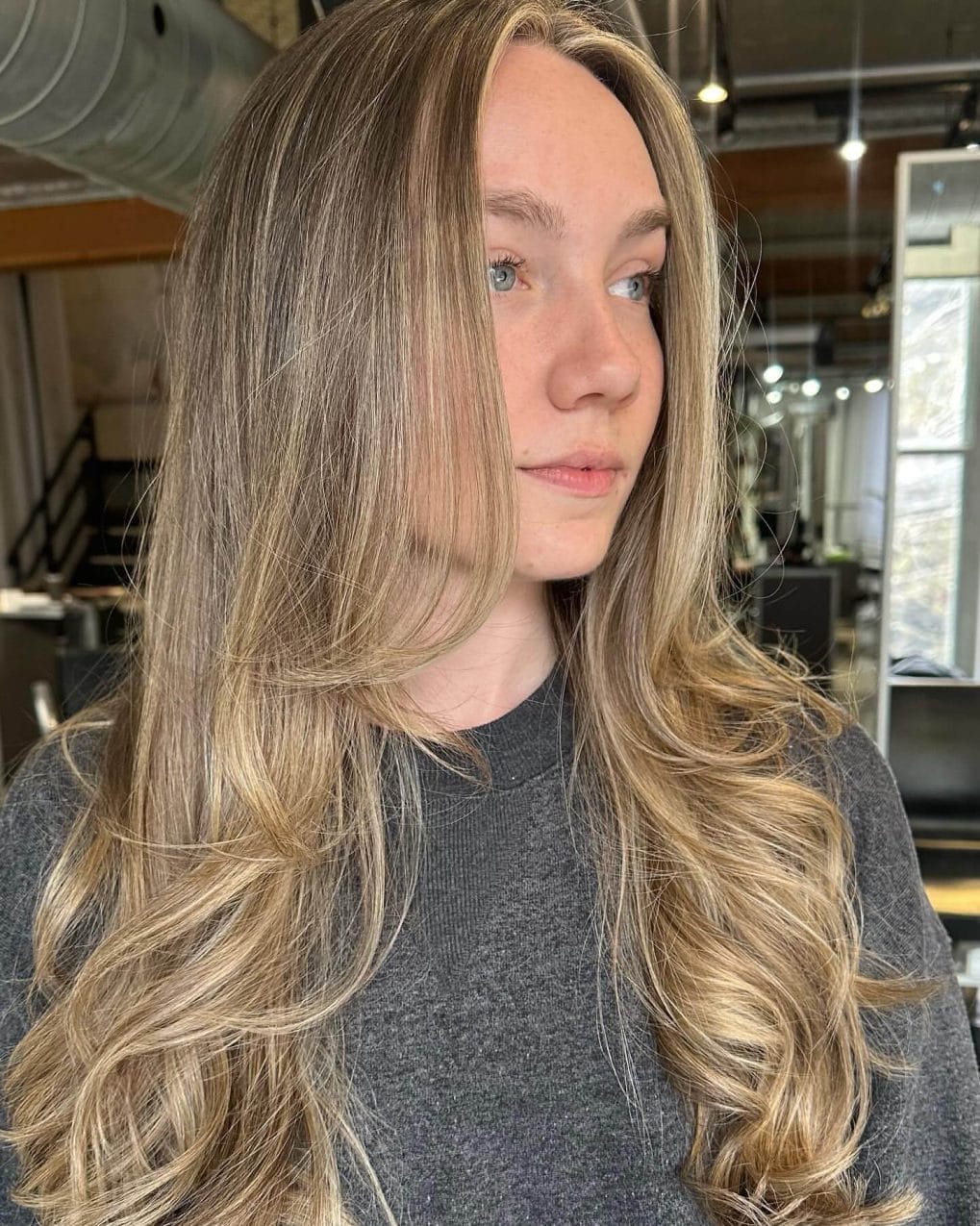Long layered waves with soft blonde and light brown balayage