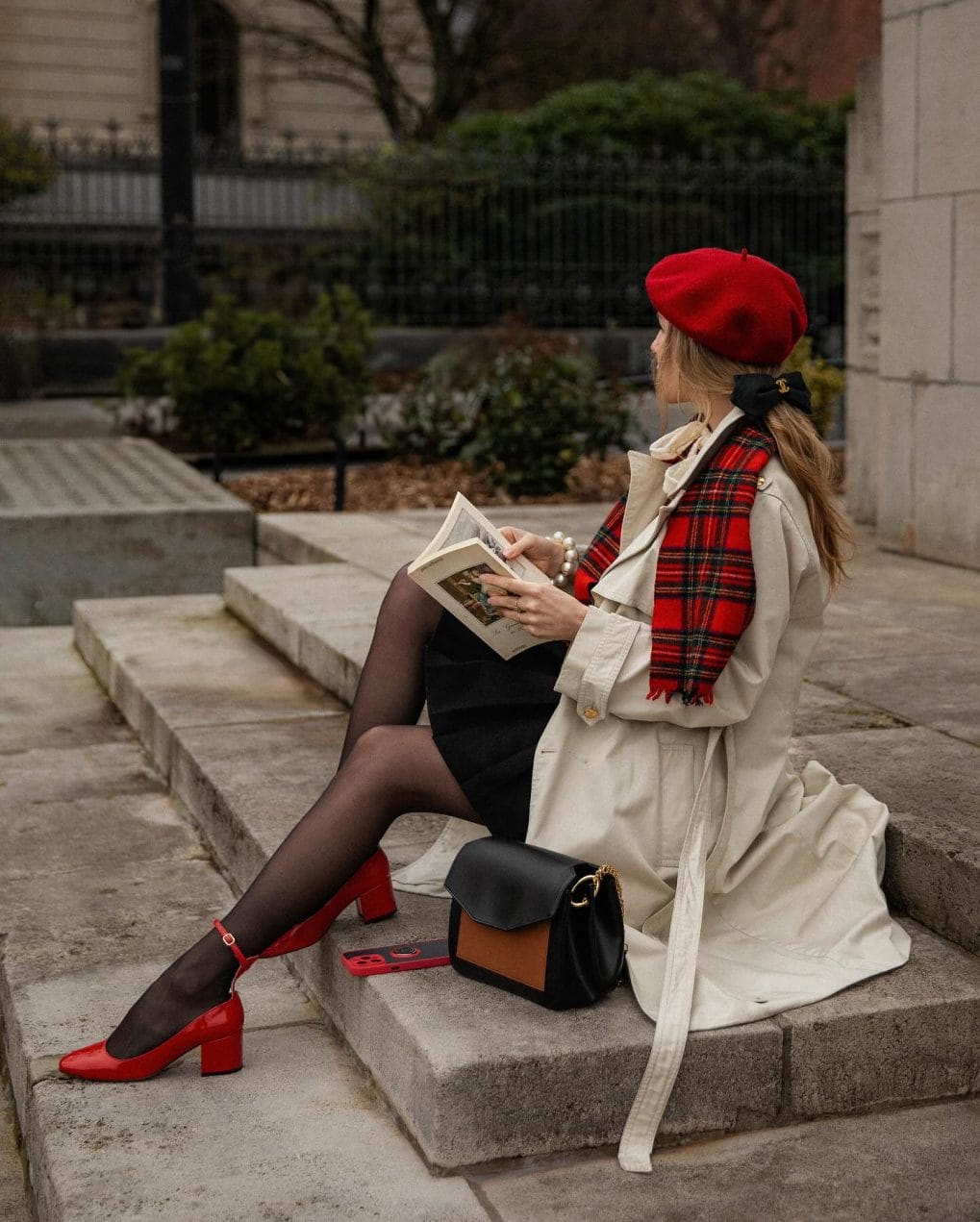 Long layered hairstyle with deep side part and loose tendrils under a red beret