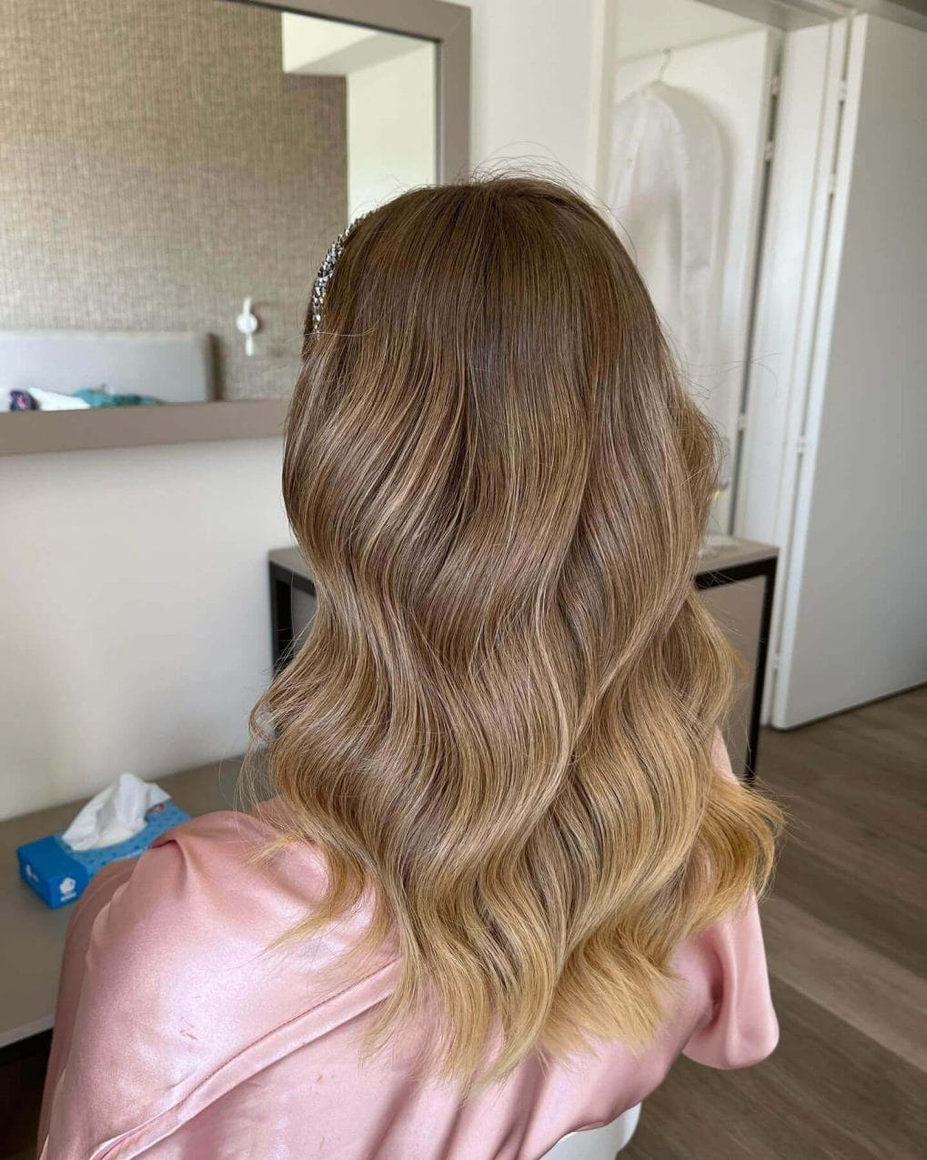 Long wavy balayage hair with a sparkling headband.