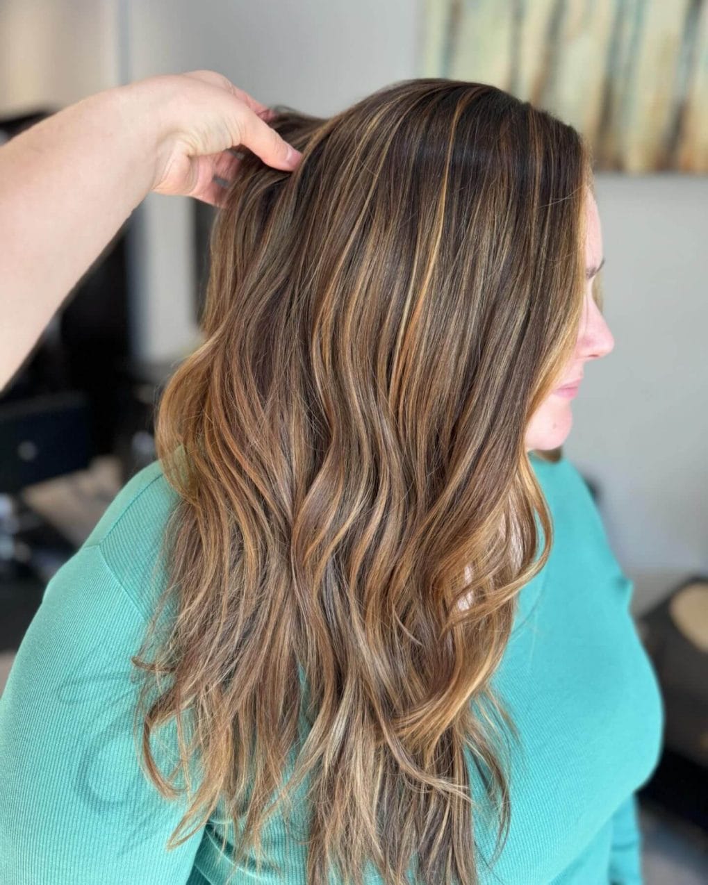 Long wavy layers with warm caramel and rich brown balayage