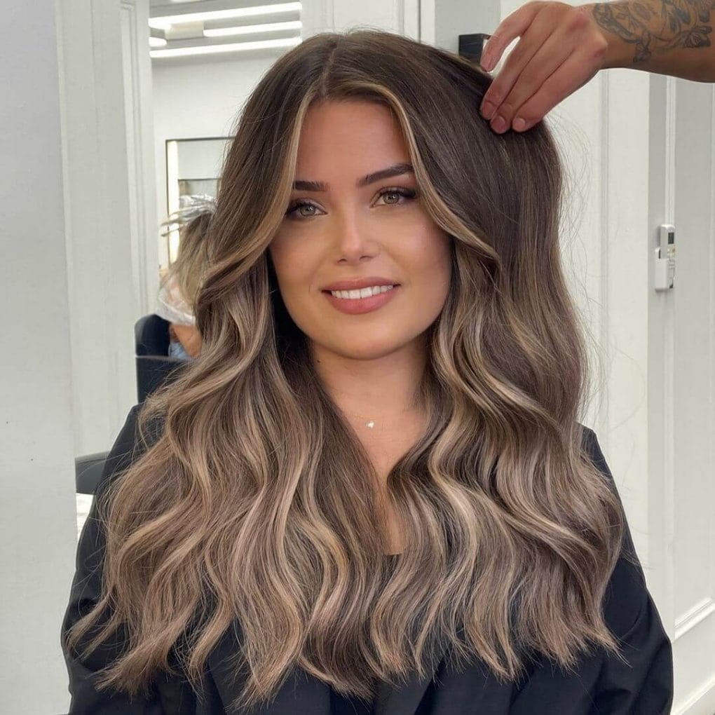 Long wavy layers with dark brown and ash blonde balayage