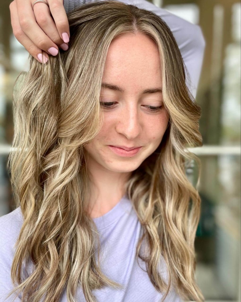 Long wavy layers with natural blonde and brown balayage