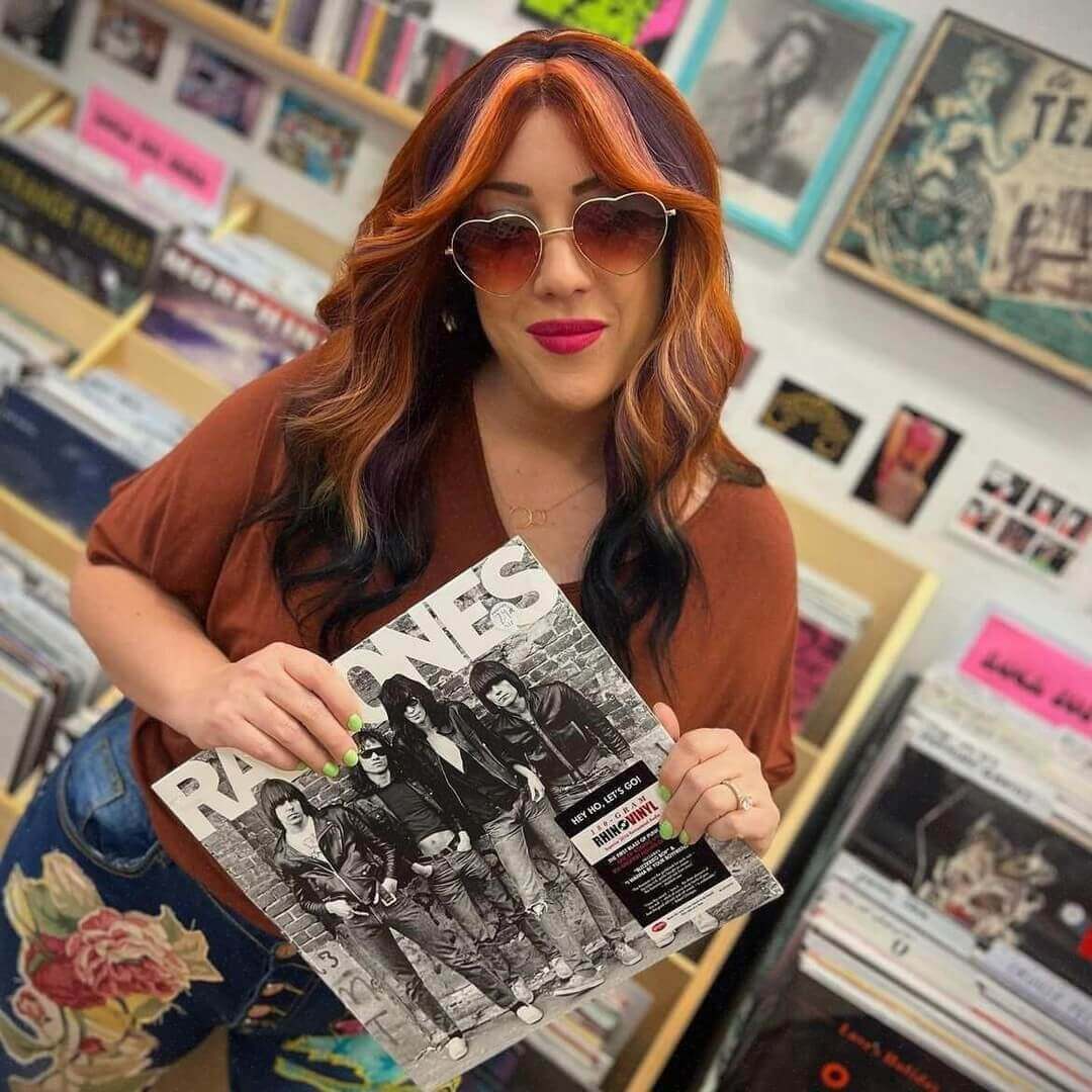 Long wavy hair with orange and dark purple chunky highlights creating an edgy style