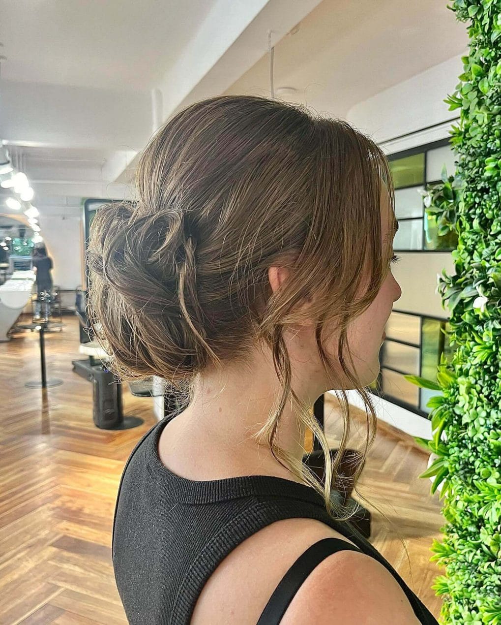 Loose low bun with soft romantic waves.