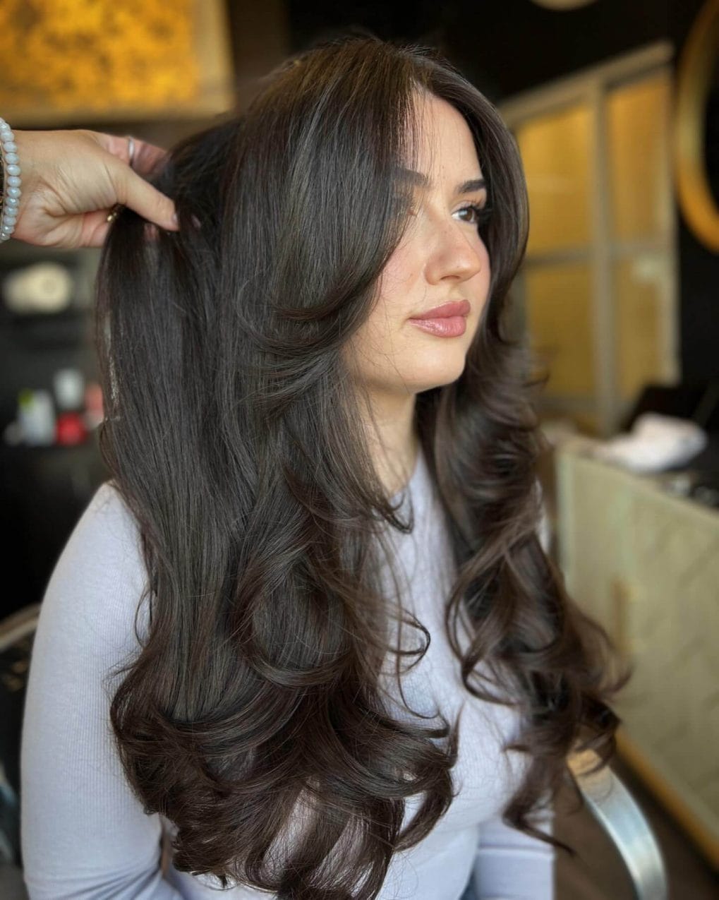 Luscious dark layers with 90s curtain bangs glam