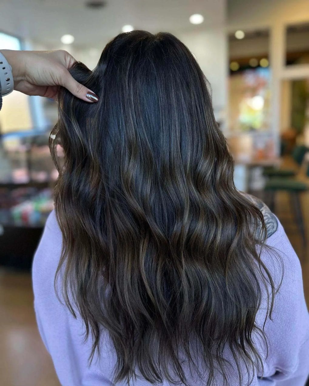 Long, luxurious waves with espresso to ash brown balayage, capturing winter's serene beauty.