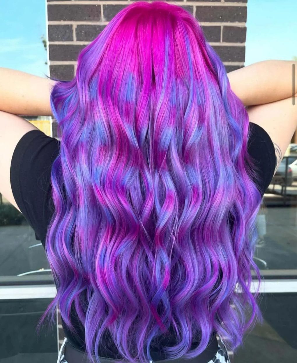 Vibrant gradient waves transitioning from magenta to pastel purple, reflecting festival boldness and creativity.
