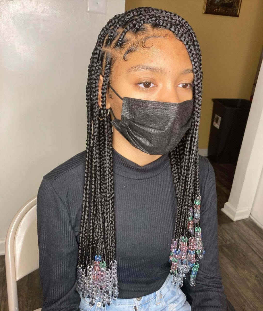 Medium-sized black braids with playful transparent and colored beads at ends.