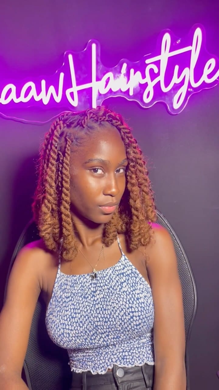 Medium-length kinky twists in brown tones softly framing the face