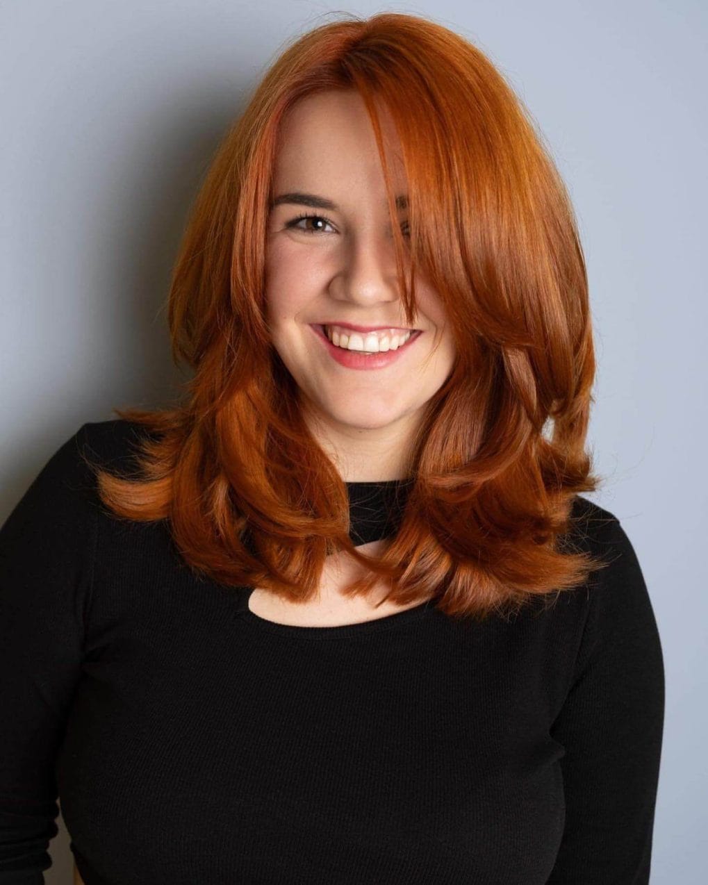 Medium copper hair with side-swept bangs