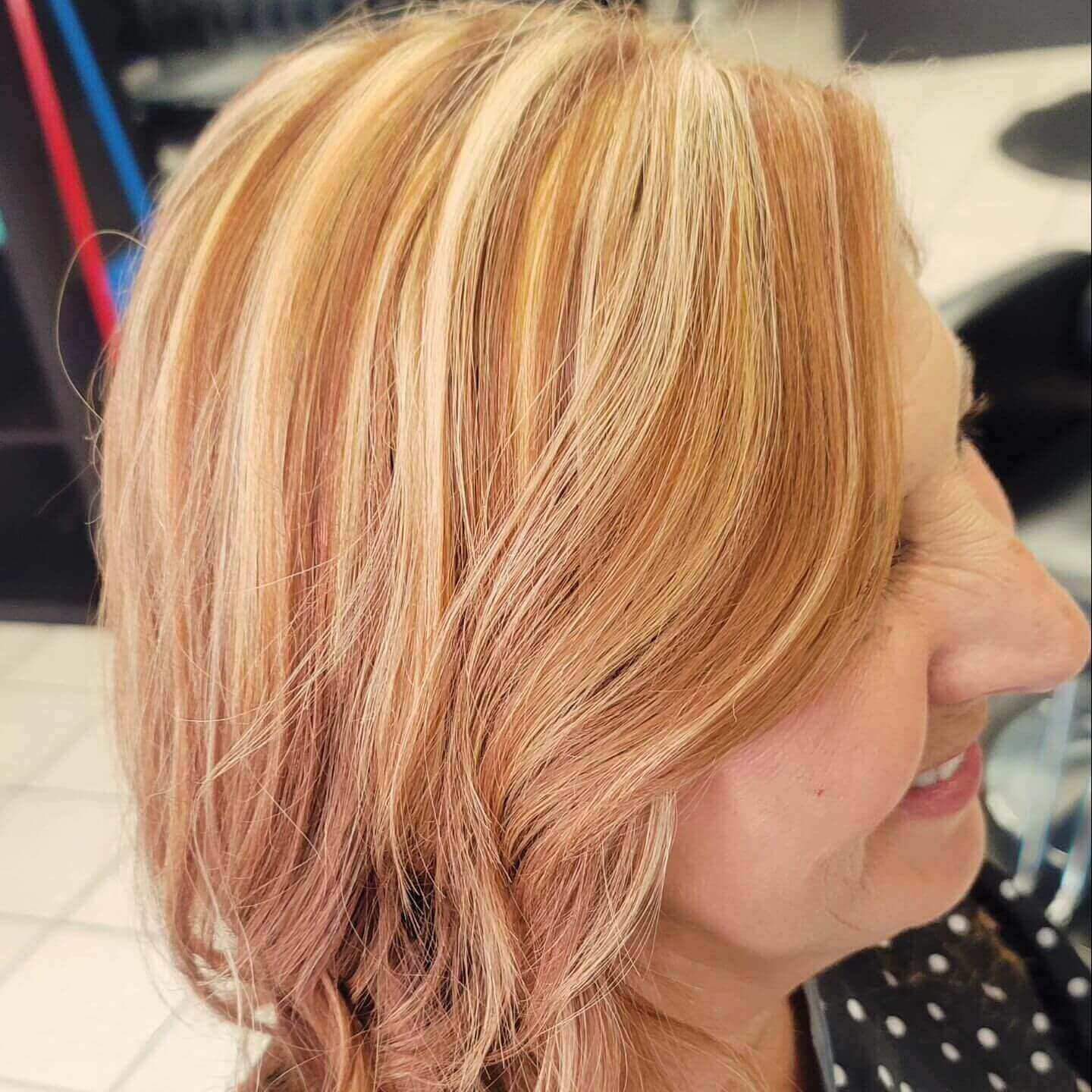 Medium softly layered hair with blonde and caramel chunky highlights for a natural look