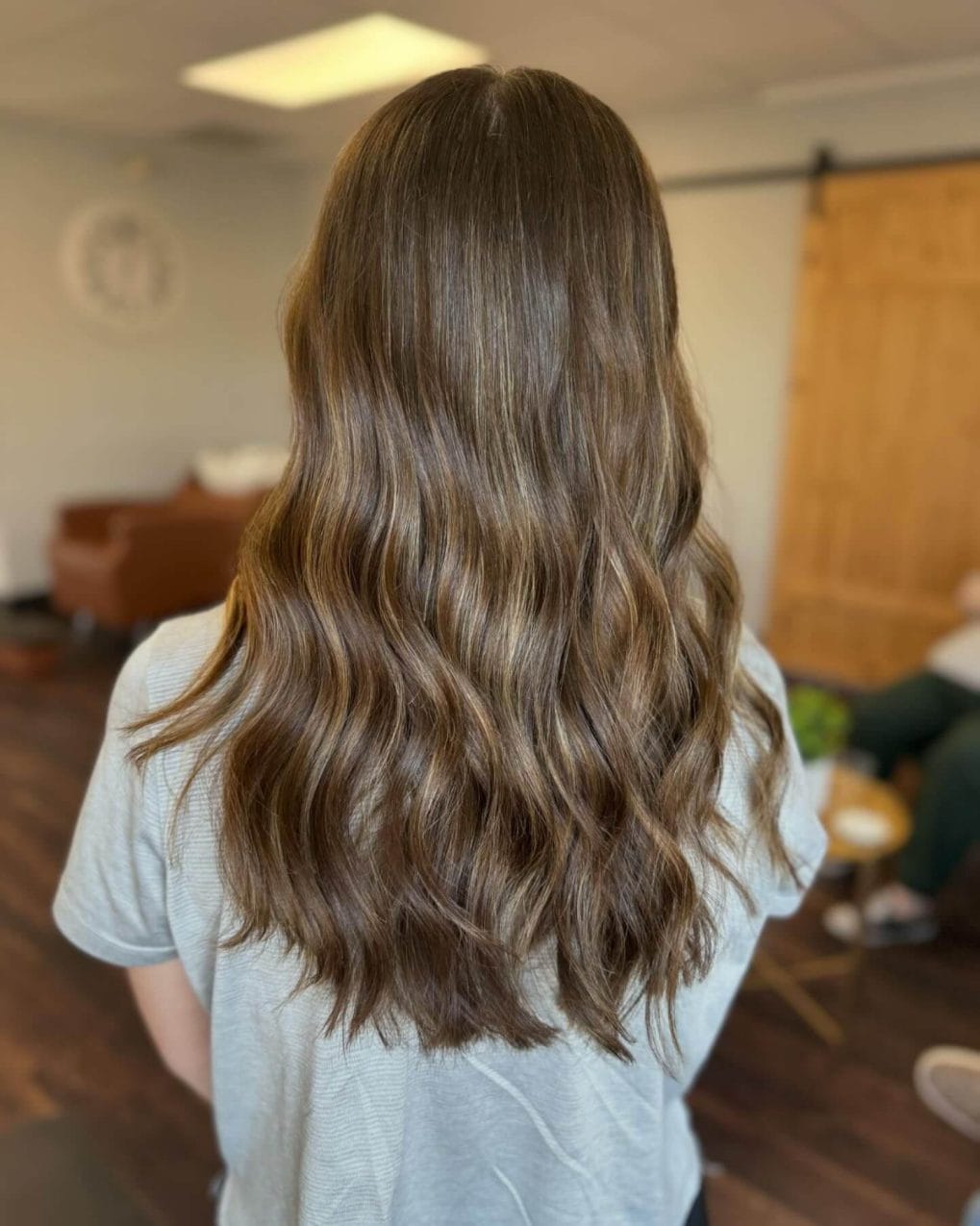 Medium-length wavy hair with soft brown balayage highlights