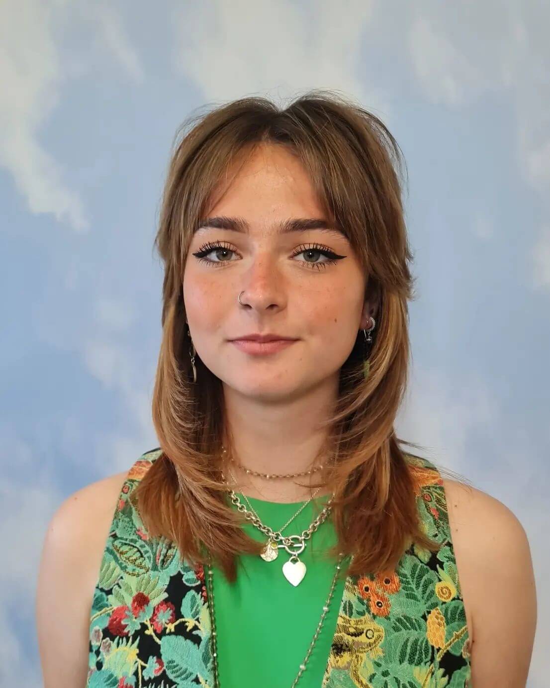 Mid-length bouncy octopus haircut with textured fringe in rich caramel.