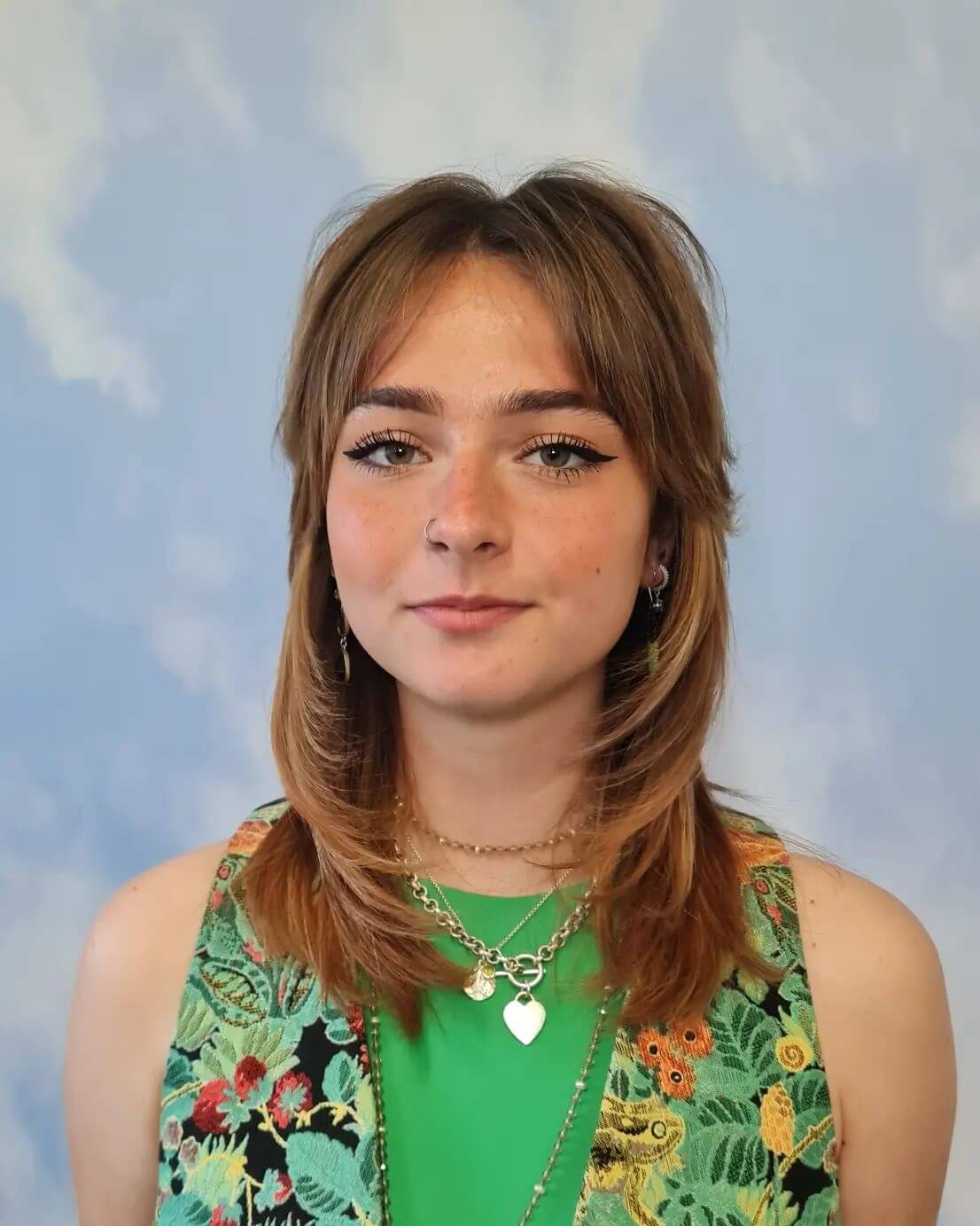 Mid-length bouncy octopus haircut with textured fringe in rich caramel.