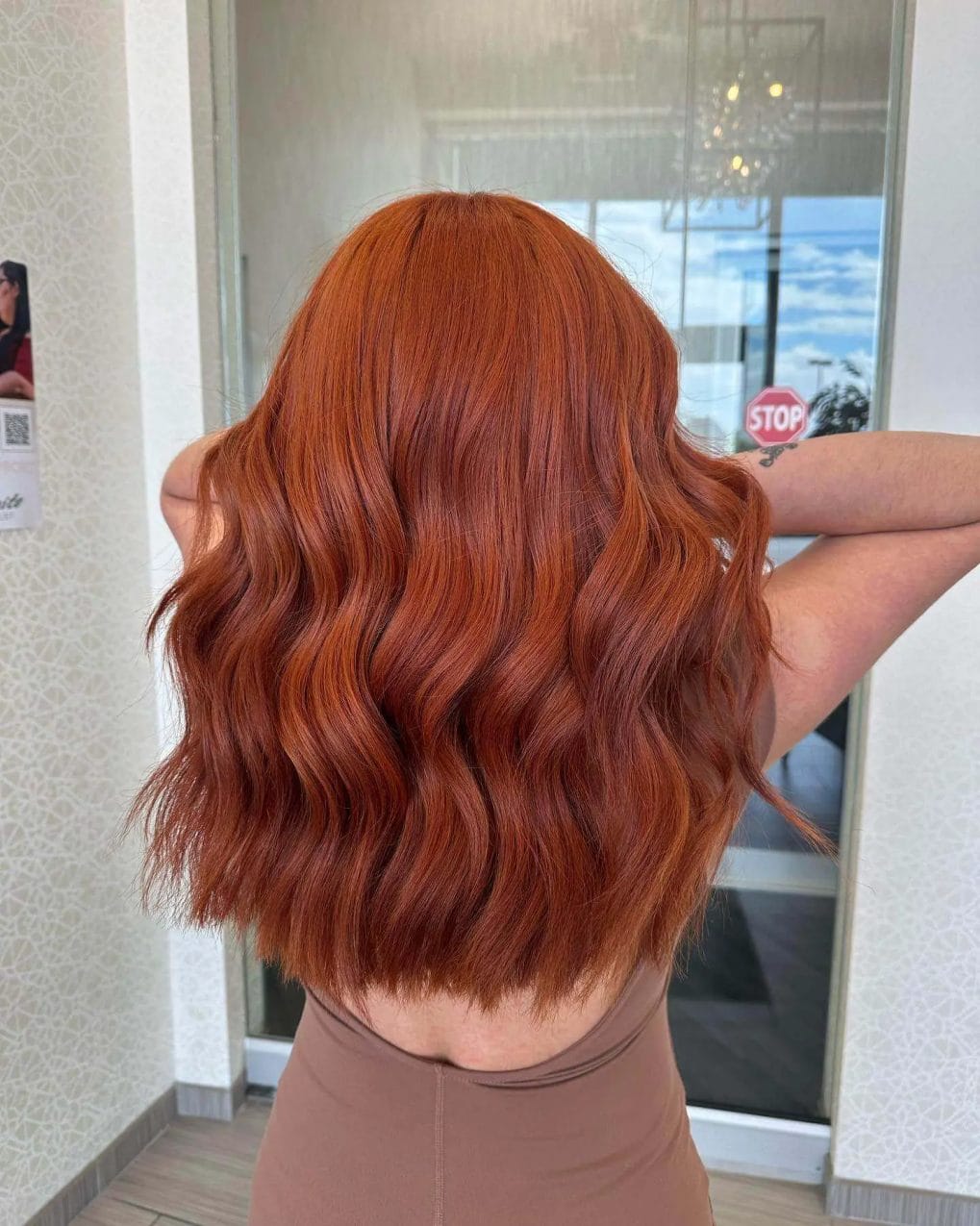Mid-length, full-bodied copper hair with seamless layers and soft waves.