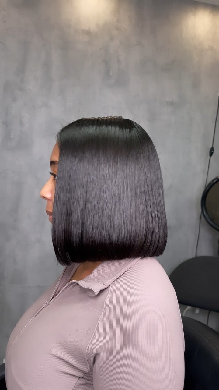 Chic bob silk press with a modern blunt cut, neatly framing the face in shiny dark tone