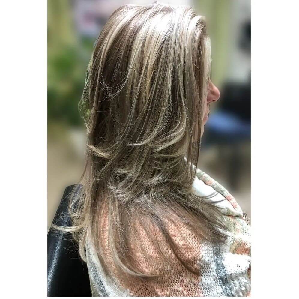 Graceful medium-length layered cut with soft highlights enhancing natural tones.