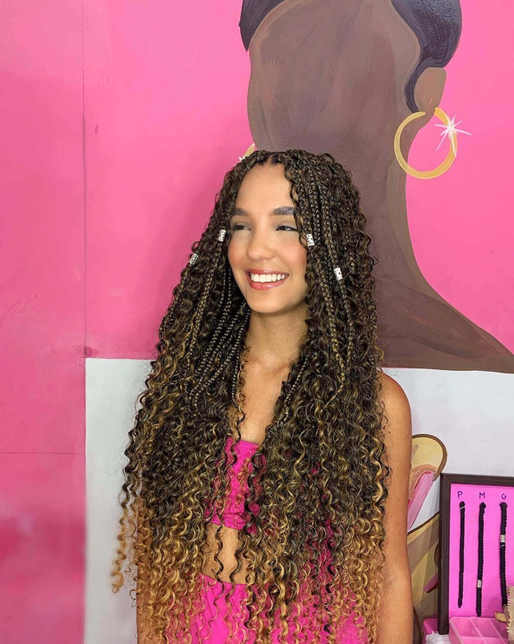 Neat cornrows open to a playful mane of tight, springy curls