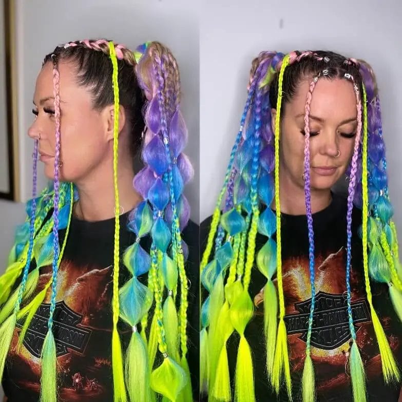 Bright neon green and blue braids and twists, reflecting a bold and individual festival style.