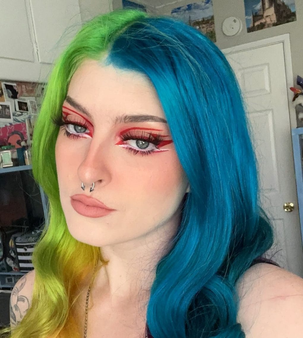 Bold neon green to electric blue transition in long wavy hair