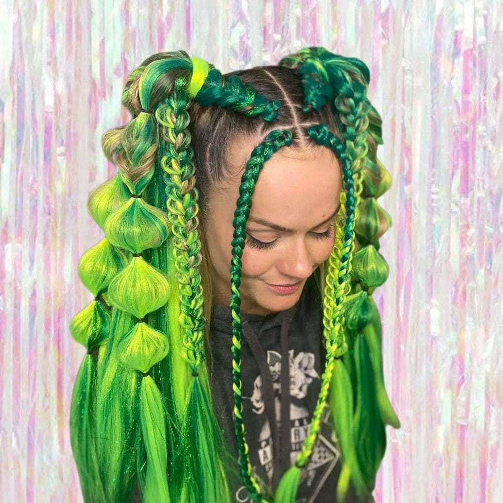 Neon green braids mixed with dark shades flowing into bubble ponytails