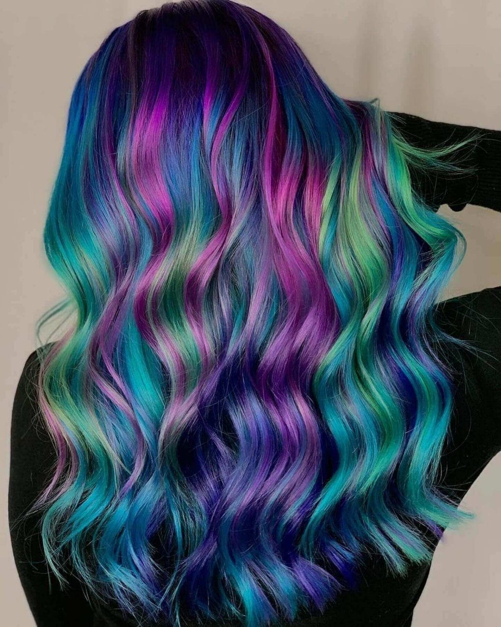 Ocean-inspired hairstyle with deep purple to sea green waves