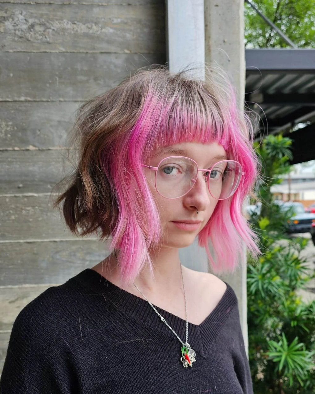 Vibrant asymmetrical haircut with pink bangs and natural mix