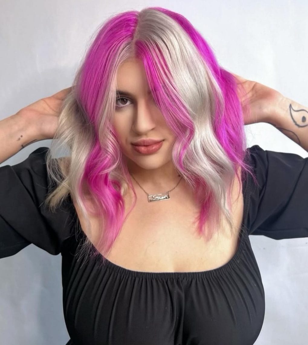 Bold pink to blonde transition in medium wavy style