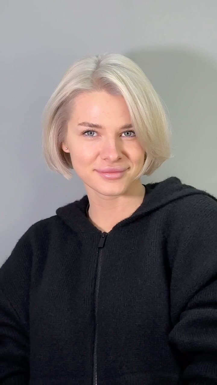 Minimalist platinum blonde '90s bob with a clean, chic cut