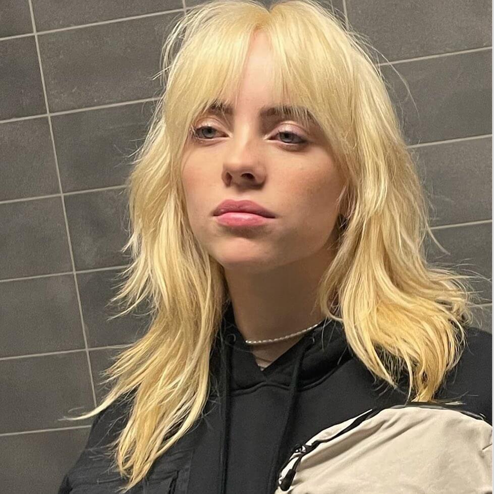 Cool platinum blonde octopus haircut with textured beachy finish.