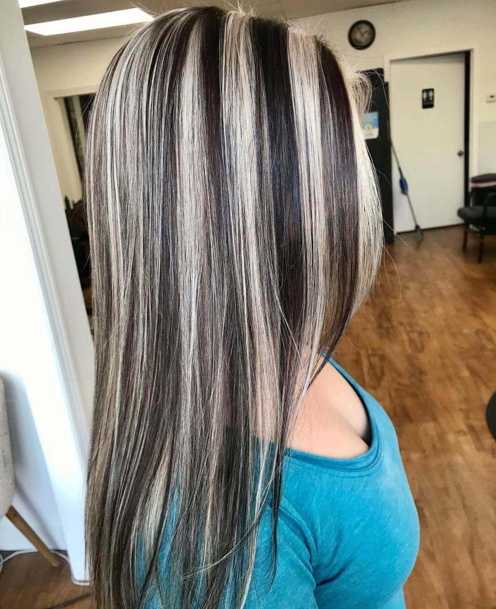 Platinum highlights through ash brown, straight long hair with subtle layers.