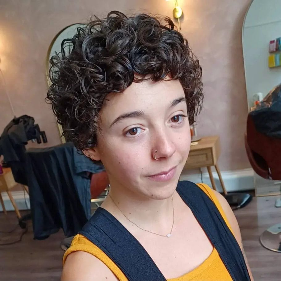 Playful pixie cut with natural volume and defined curls.