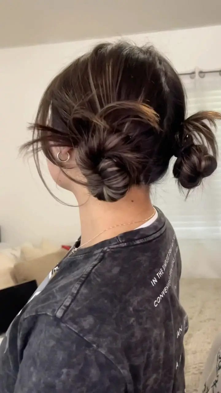 Playful double buns in dark brown, ensuring hair stays up during exercise