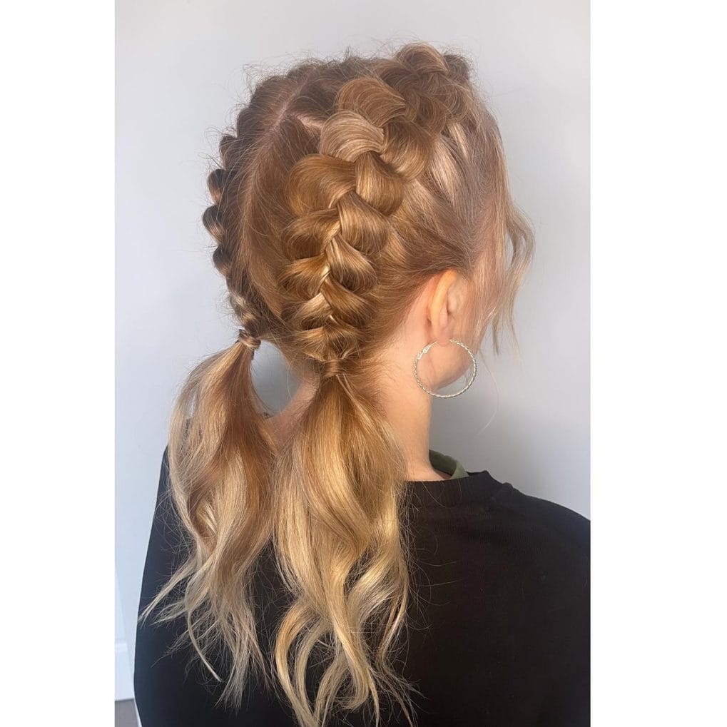 Light brown half-up double Dutch braids into playful curls for sporty expression
