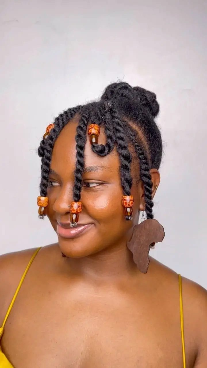 Playful high bun with chunky twists and vibrant beads